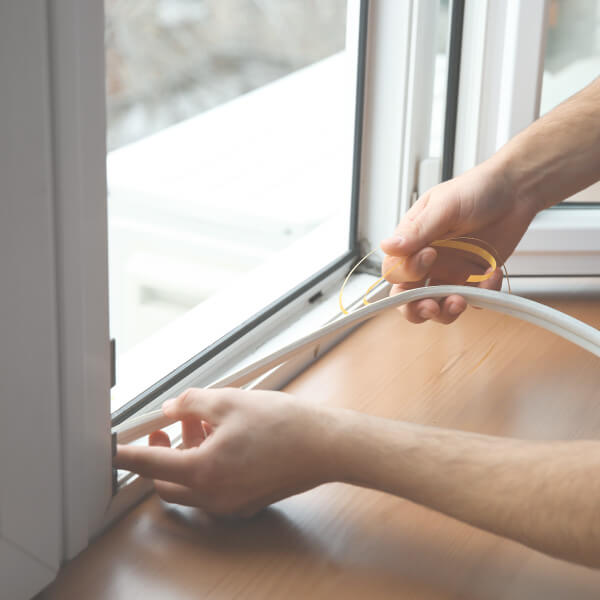 man-applying-window-seal